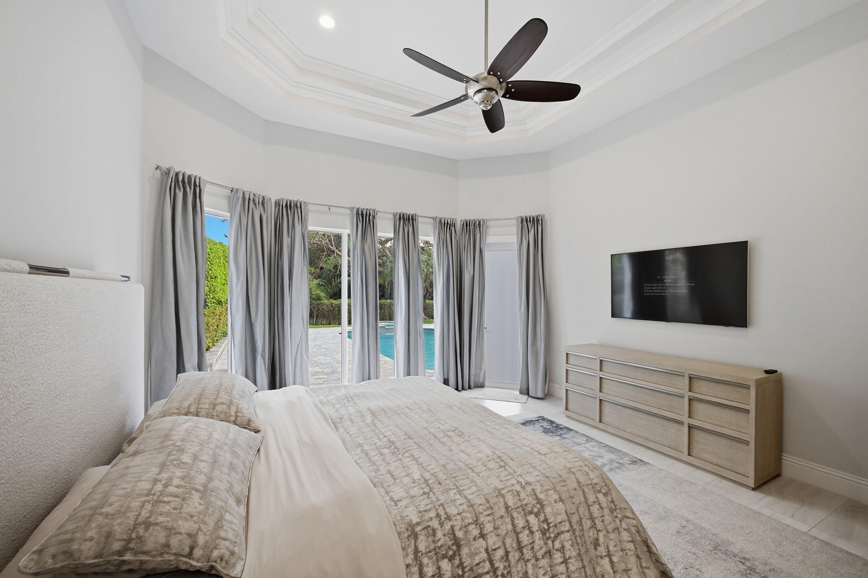 5006 Northwest 24th Circle Boca Raton, FL 33431 - Photo 20 of 52 a bedroom with a bed and a flat screen tv