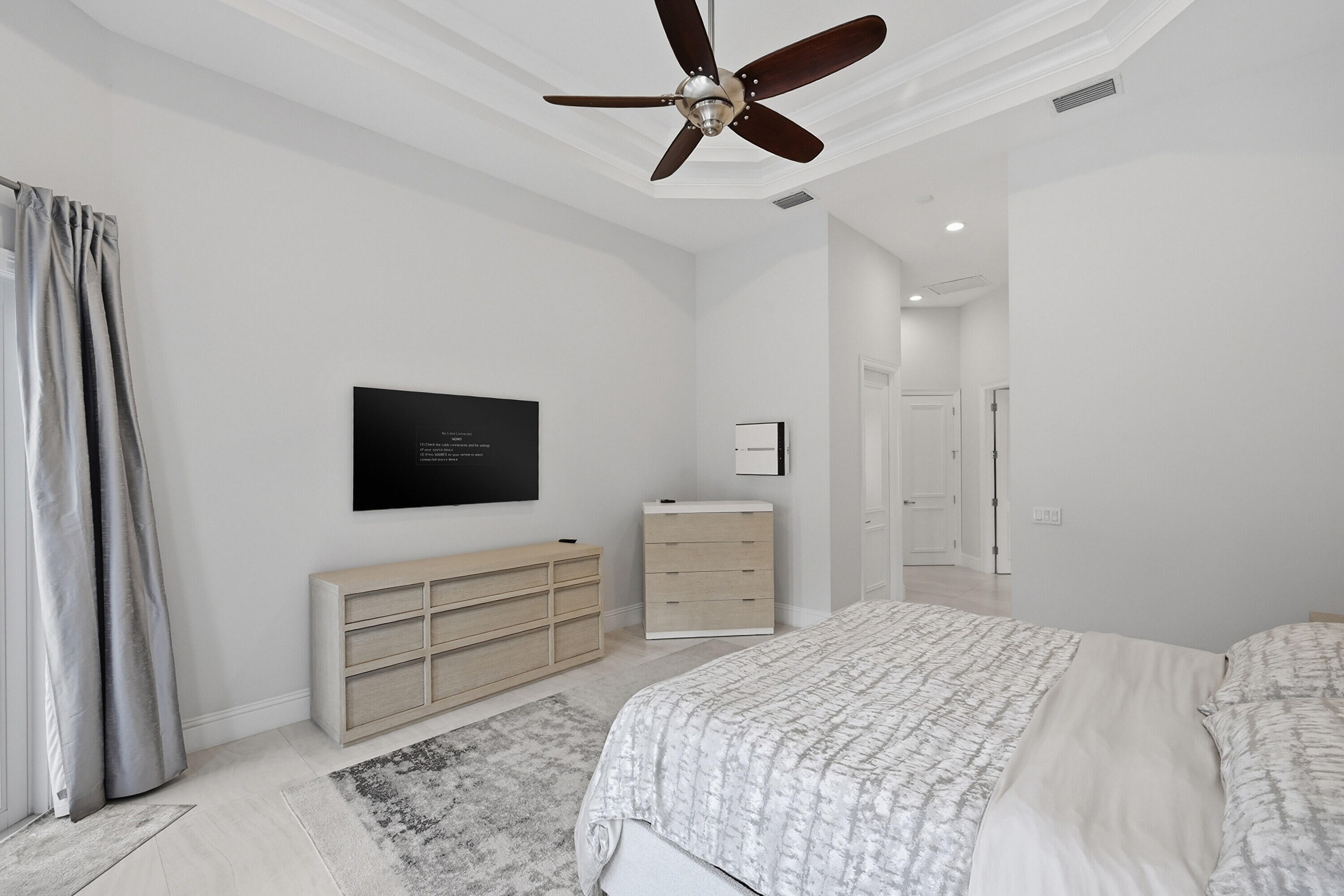 5006 Northwest 24th Circle Boca Raton, FL 33431 - Photo 21 of 52 a bedroom with a bed and a flat screen tv