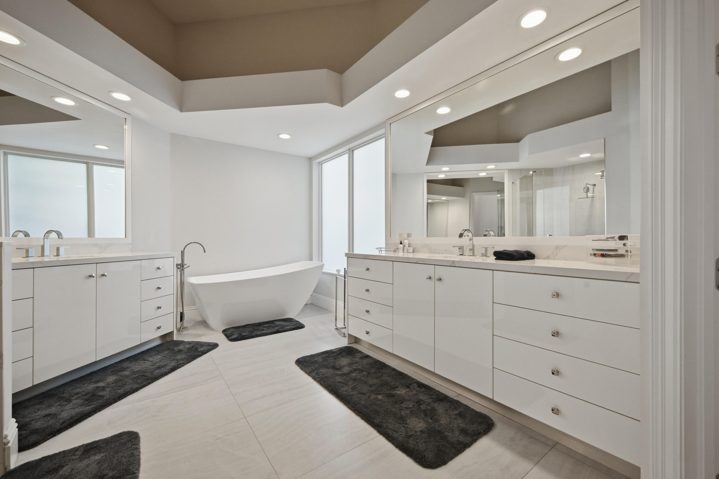 5006 Northwest 24th Circle Boca Raton, FL 33431 - Photo 23 of 52 a bathroom with a double vanity sink a mirror and a