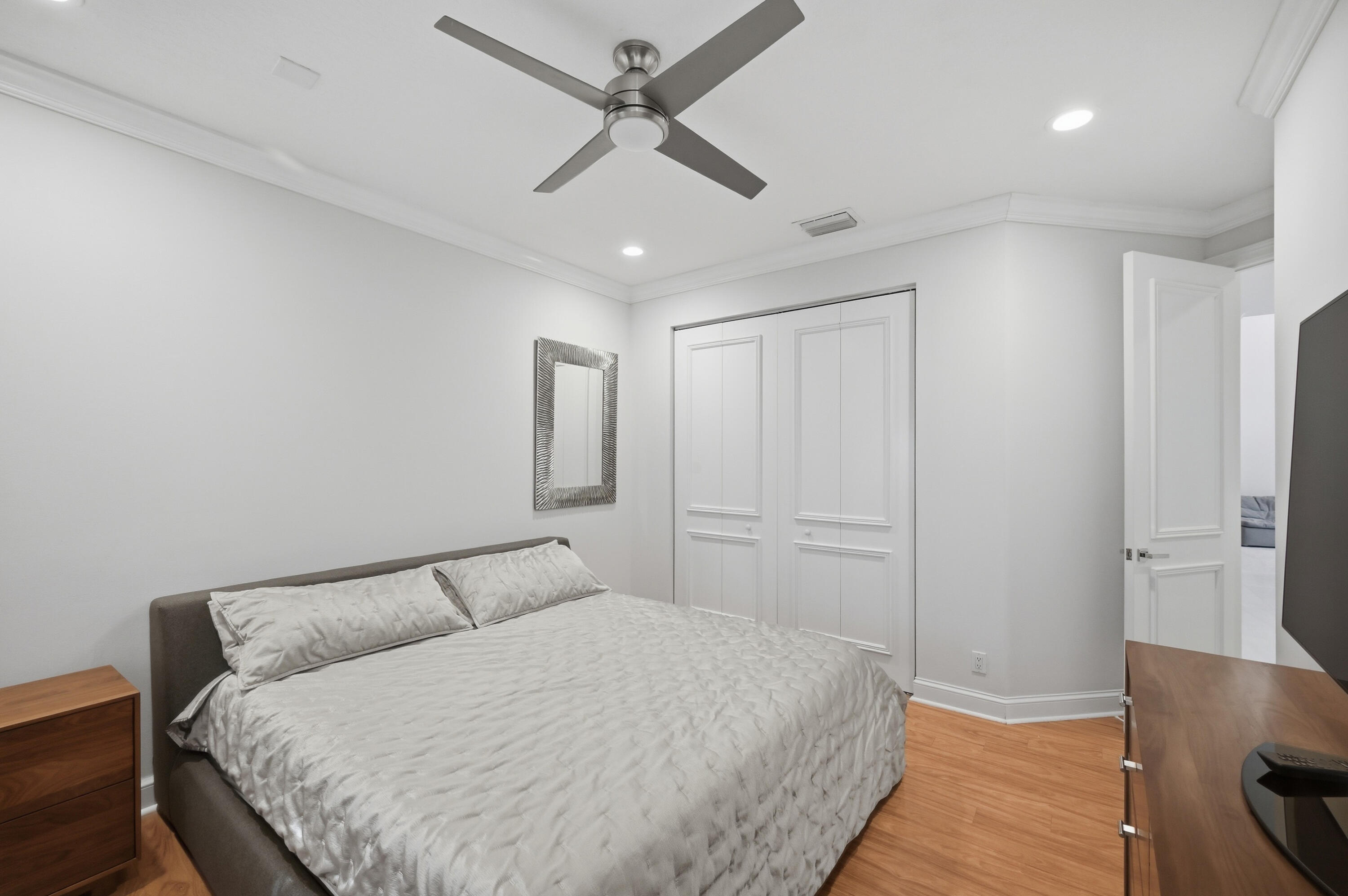 5006 Northwest 24th Circle Boca Raton, FL 33431 - Photo 32 of 52 a bedroom with a bed and a ceiling fan