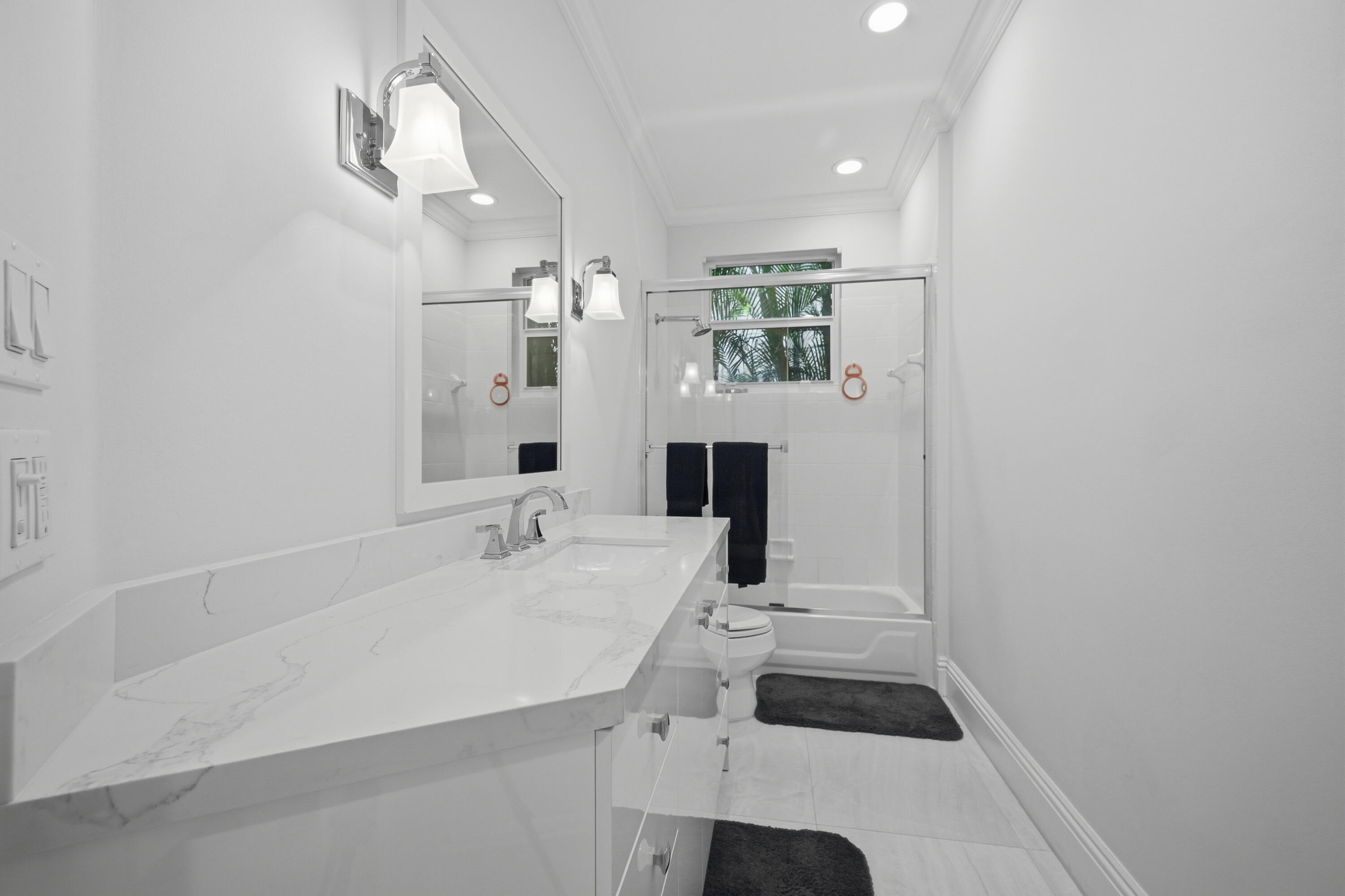 5006 Northwest 24th Circle Boca Raton, FL 33431 - Photo 33 of 52 a bathroom with a sink a toilet and mirror