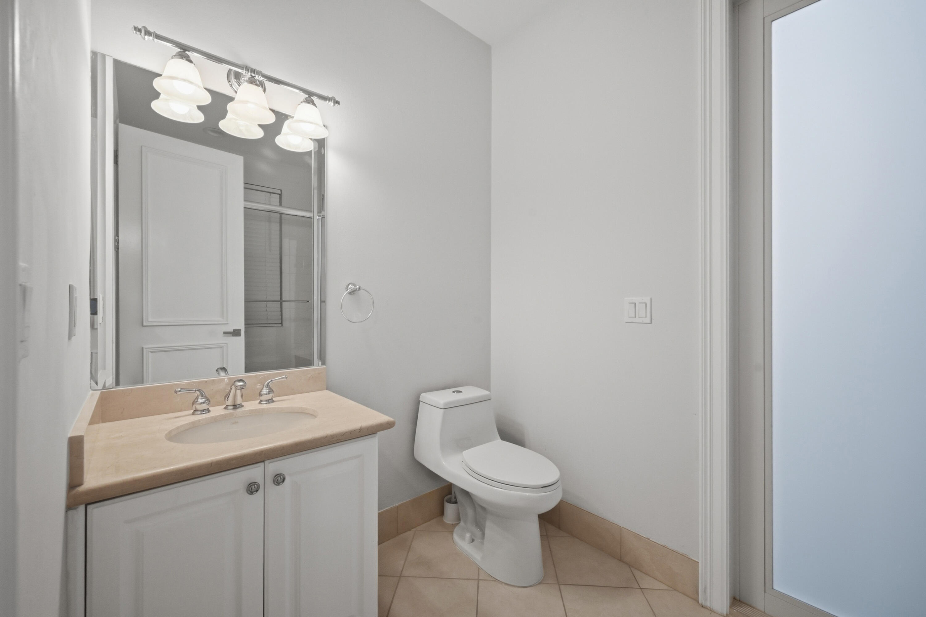 5006 Northwest 24th Circle Boca Raton, FL 33431 - Photo 36 of 52 a bathroom with a toilet a sink and mirror