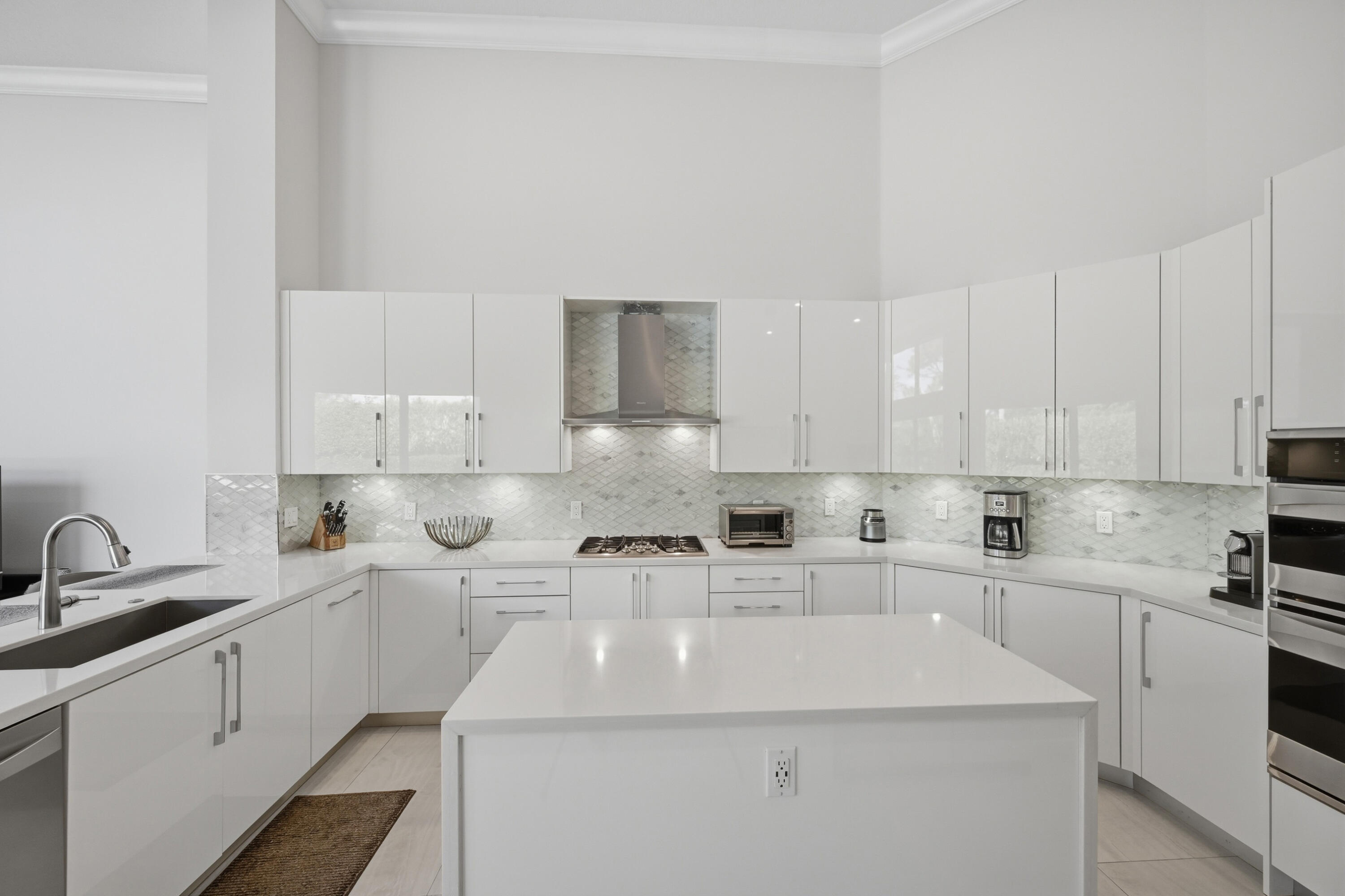5006 Northwest 24th Circle Boca Raton, FL 33431 - Photo 7 of 52 a kitchen with cabinets a sink and white appliances