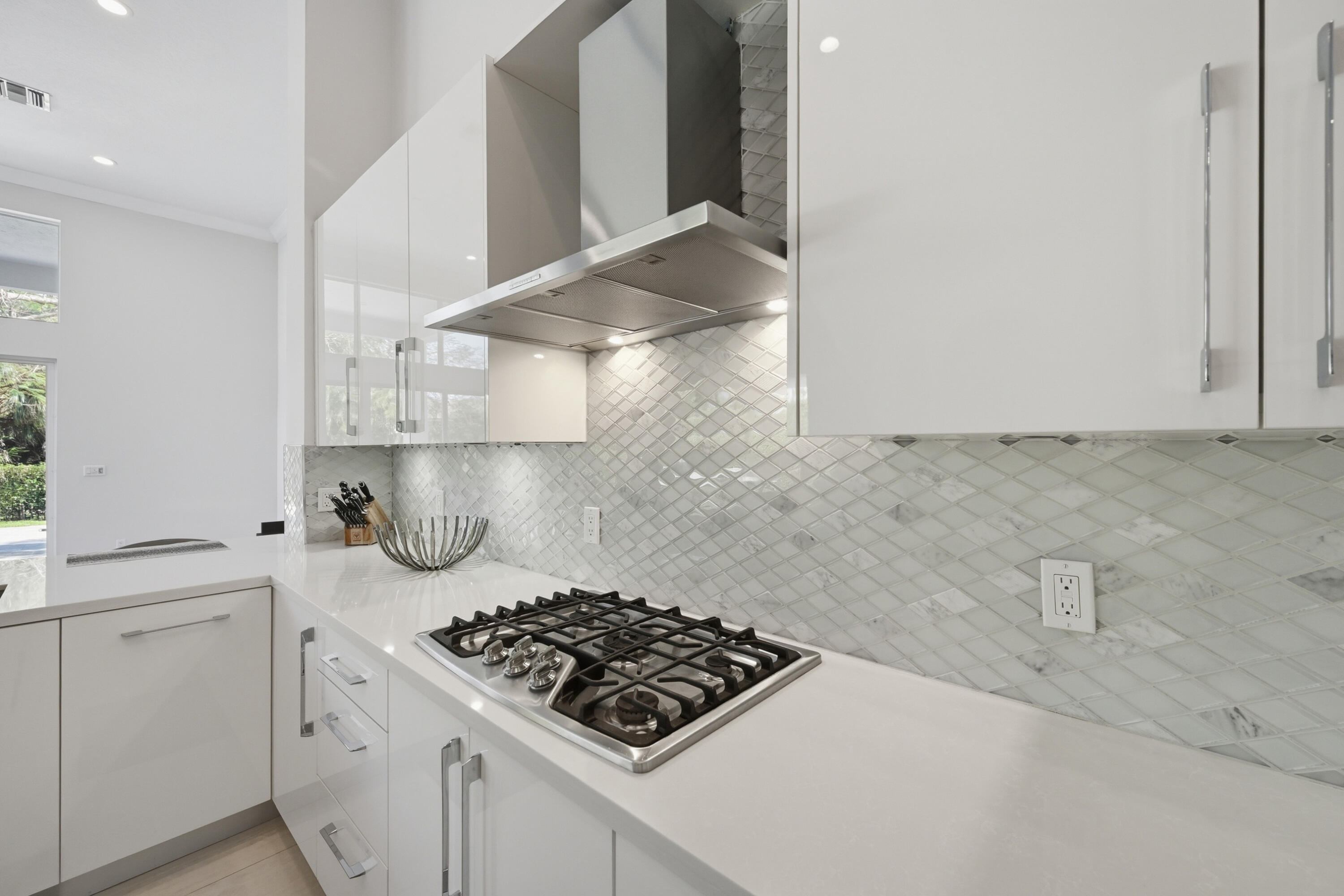 5006 Northwest 24th Circle Boca Raton, FL 33431 - Photo 9 of 52 a kitchen with white cabinets and a stove