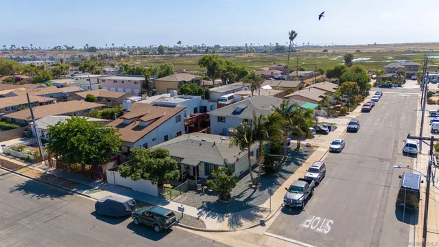 an aerial view of a house with a yard and sitting area