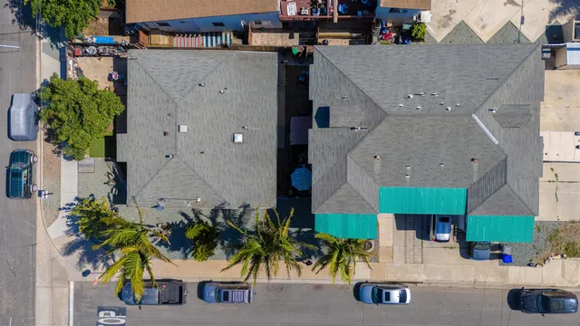 an aerial view of a house with yard and patio