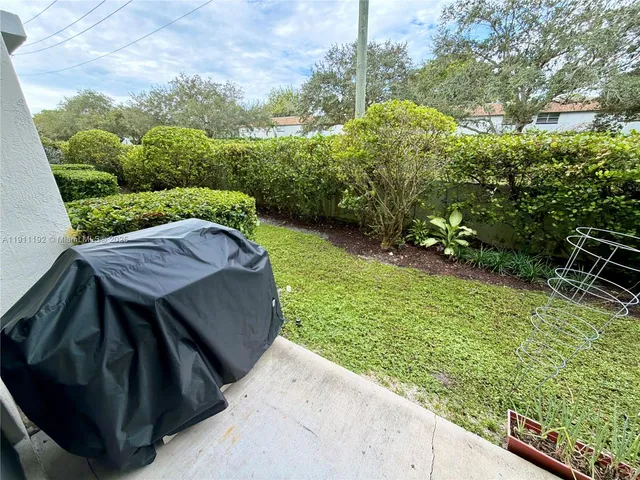 a view of a chairs and table in patio