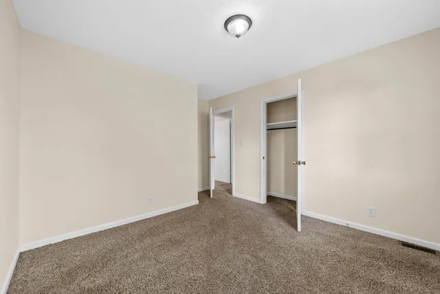 a view of an empty room and closet area