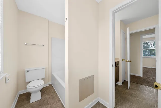 a bathroom with a toilet and a shower