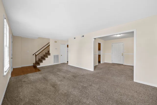 a view of an empty room with stairs