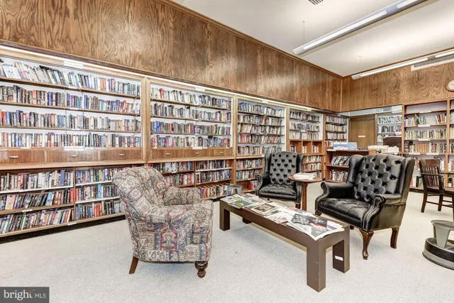 a reading room with furniture and book shelf