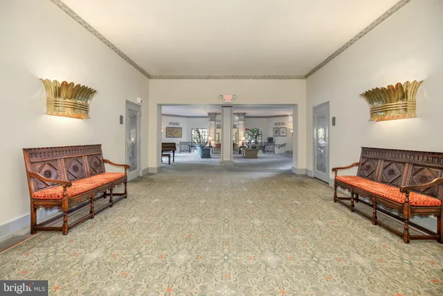 a living room with furniture and a dining table