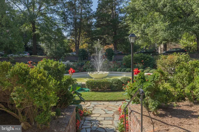 a view of a garden with flowers and trees