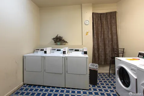 a kitchen with stainless steel appliances a stove a refrigerator and a window