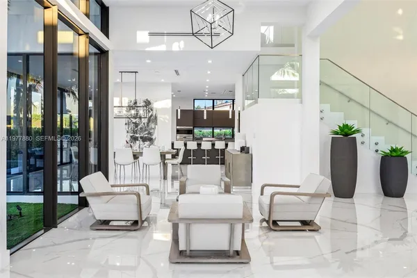 a living room with furniture a rug and a large window
