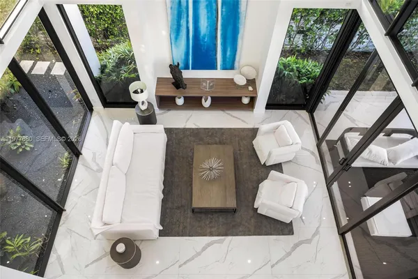 a large white kitchen with a large window