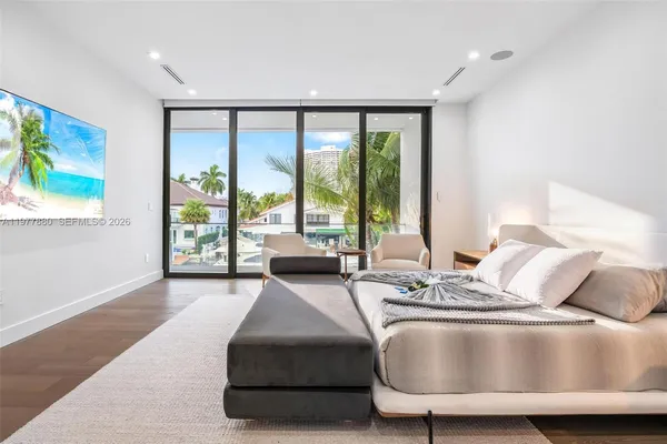 a living room with patio furniture and a floor to ceiling window
