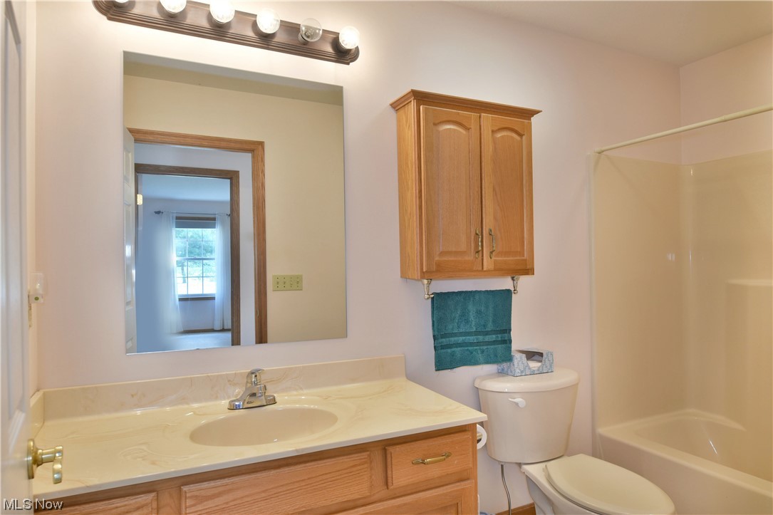 2033 East River Road, Unit 11 Newton Falls, OH 44444 - Photo 18 of 35 Full bathroom featuring large vanity, mirror, and bathtub / shower combination