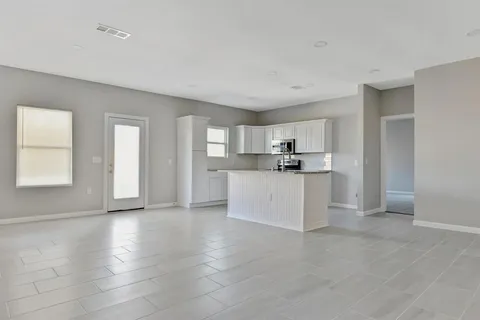 a view of a kitchen with microwave and cabinets