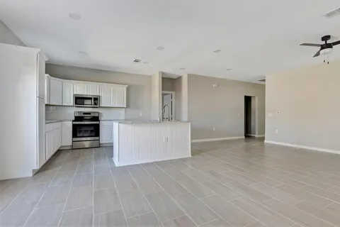 a view of kitchen electric appliances and cabinets