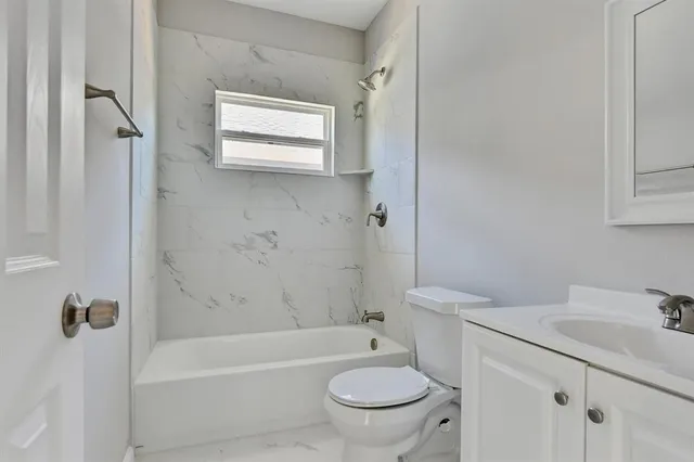 a bathroom with a toilet a sink and bathtub