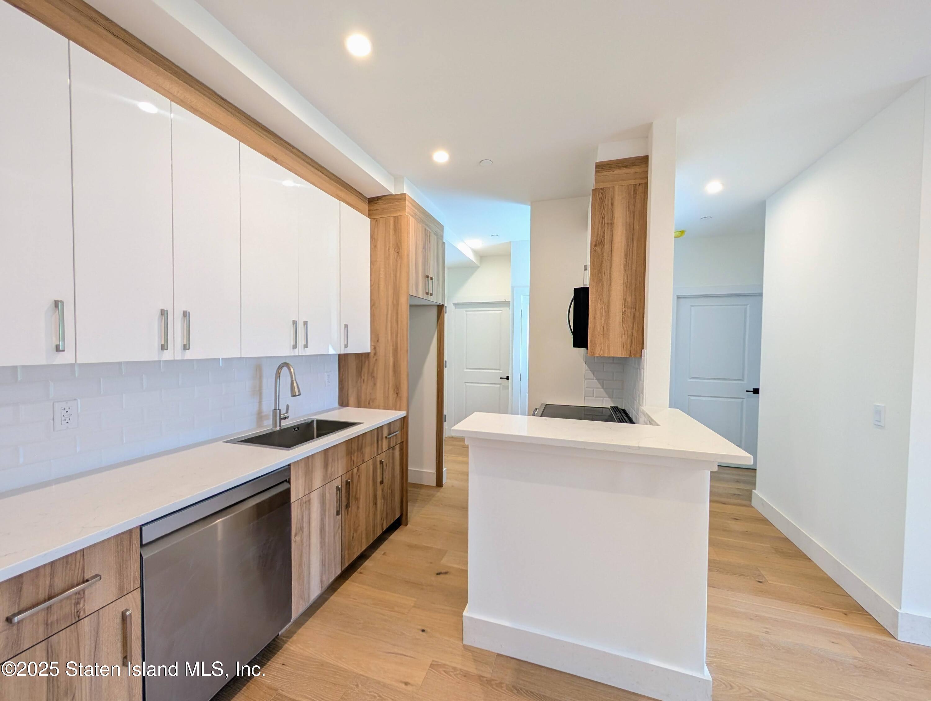 3865 Amboy Road, Unit 4D Staten Island, NY 10308 - Photo 12 of 32 a kitchen with stainless steel appliances granite countertop a sink a stove and a refrigerator