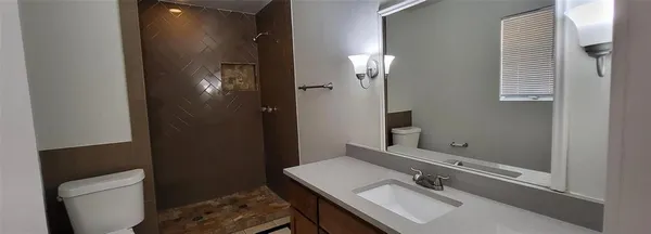 a bathroom with a sink vanity and a mirror
