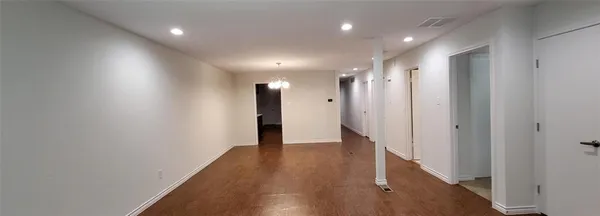 a view of hallway with stairs and wooden floor
