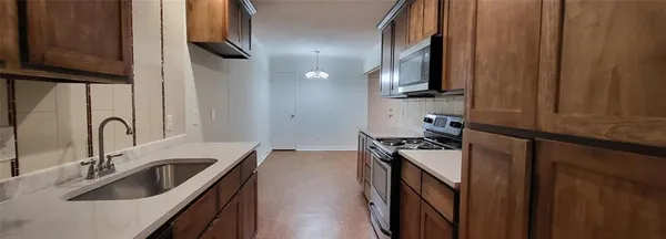a kitchen with a sink stove and microwave