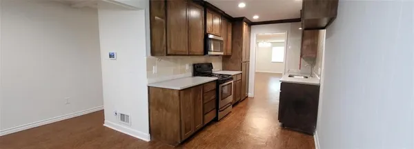 a kitchen with stainless steel appliances granite countertop a sink and a stove top oven