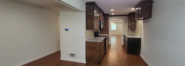 a view of hallway with wooden floor