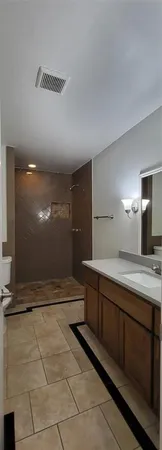 a bathroom with a sink a toilet and mirror