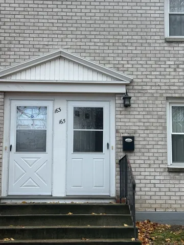 a white building with black door