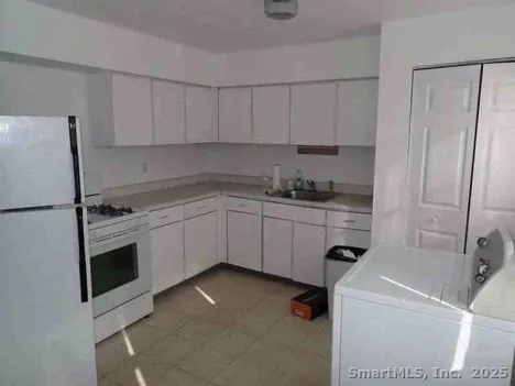 a kitchen with a sink cabinets and stainless steel appliances
