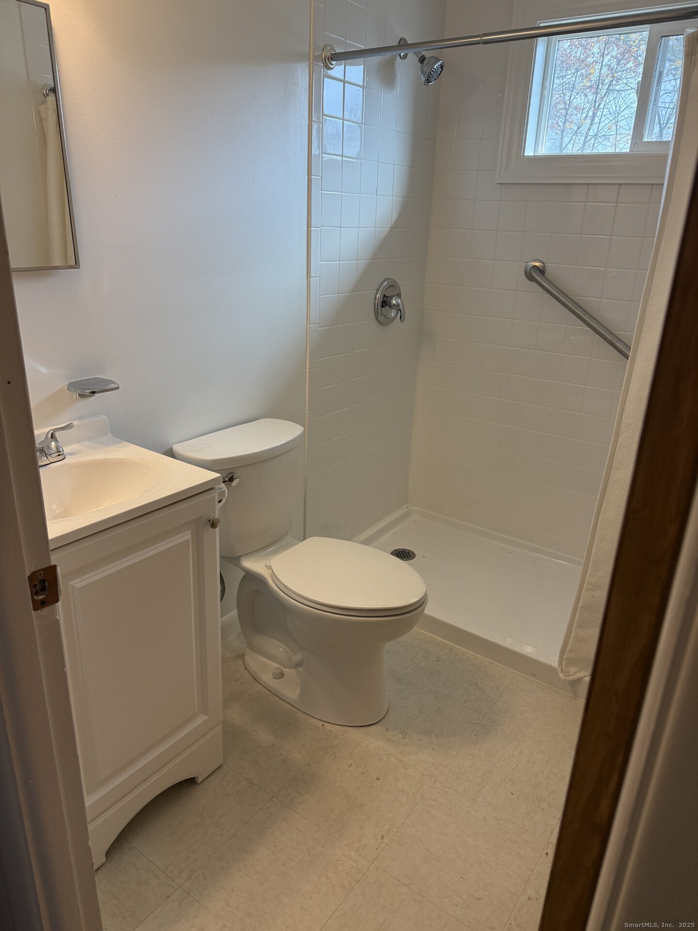 165 Yaremich Drive Bridgeport, CT 06606 - Photo 7 of 9 a white toilet sitting next to a bathroom sink