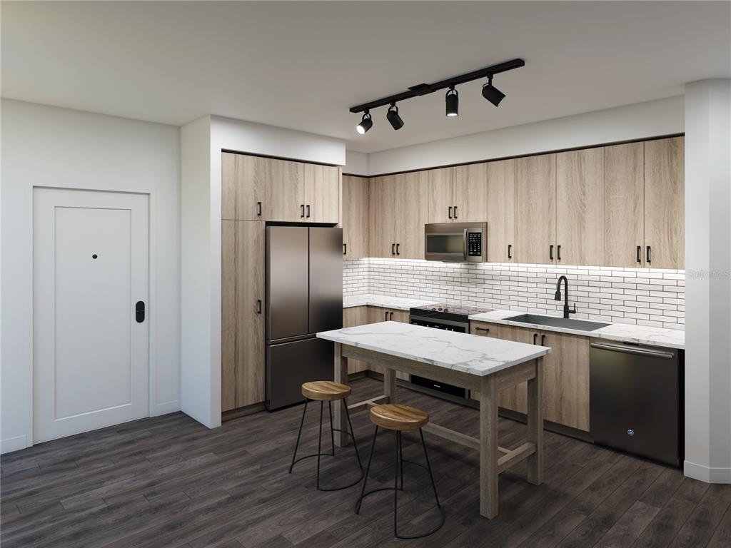 901 West Chestnut Street, Unit B507 Tampa, FL 33607 - Photo 11 of 20 a kitchen with stainless steel appliances granite countertop a refrigerator a stove a sink dishwasher a dining table and chairs with wooden floor