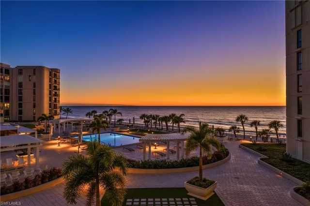 a view of a swimming pool with a table and chairs