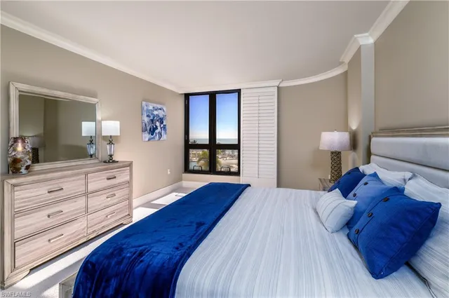 a bedroom with a large bed and a dresser