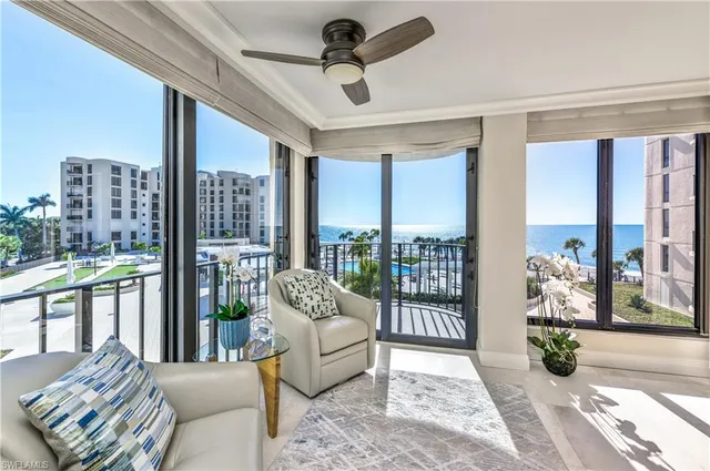 a living room with furniture and a floor to ceiling window