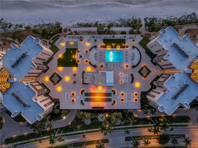 an aerial view of a building with outdoor space and swimming pool