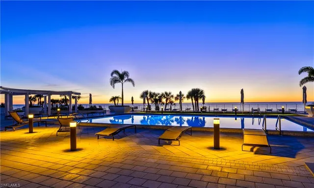 a view of swimming pool with a table and chairs