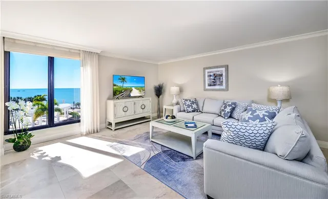 a living room with furniture and a potted plant
