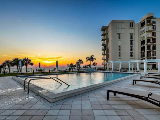 a view of swimming pool with outdoor seating and city view