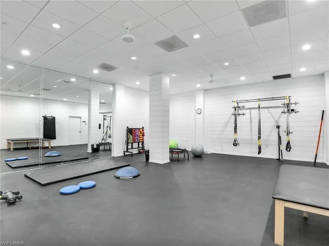 a view of a gym room with gym equipment