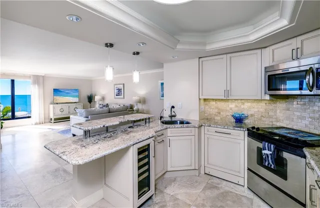 a kitchen with a stove a sink and a microwave