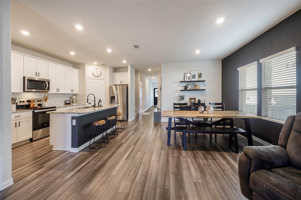 307 Quarry Street Melissa, TX 75454 - Photo 11 of 25 a living room with stainless steel appliances furniture wooden floor and a view of kitchen