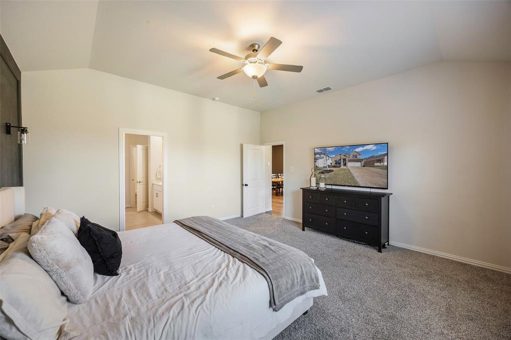 307 Quarry Street Melissa, TX 75454 - Photo 13 of 25 a bedroom with a bed and a ceiling fan