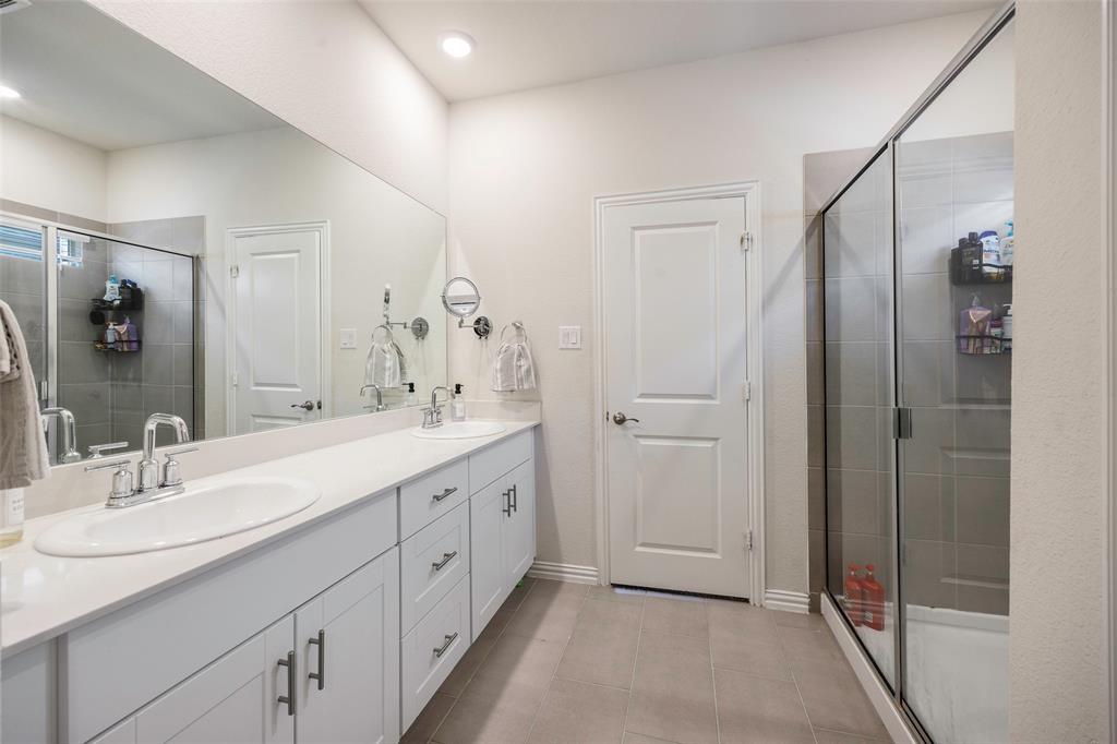 307 Quarry Street Melissa, TX 75454 - Photo 15 of 25 a spacious bathroom with a double vanity sink a mirror and a shower