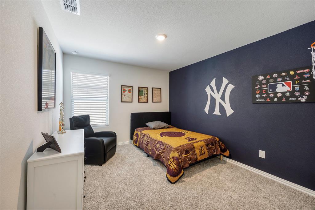 307 Quarry Street Melissa, TX 75454 - Photo 21 of 25 a bedroom with a bed and a couch