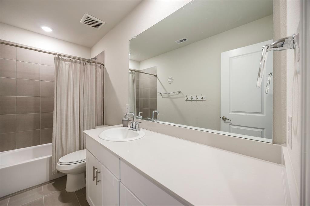 307 Quarry Street Melissa, TX 75454 - Photo 22 of 25 a bathroom with a granite countertop sink toilet and shower